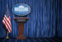 Record-Breaking Exit Rattles Washington White House press briefing podium with U.S. flag and blue curtain