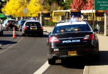 Interstate Chaos: Kids Targeted After Crash Police cars with lights on near school buses on a city street