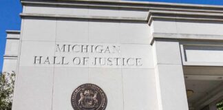 Eight Words Detonate Michigan Race Michigan Hall of Justice exterior wall with state seal