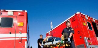 Systemwide Closures After Shocking Ejection Paramedics move a patient on a stretcher between red ambulances