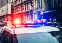 E-Bike Thugs Slash NYPD Detective Police car with flashing lights in city street