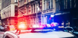 E-Bike Thugs Slash NYPD Detective Police car with flashing lights in city street