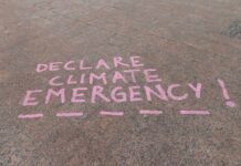 Climate Math Shocks: 2.8°C On Deck Pink chalk message on pavement