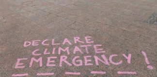 Climate Math Shocks: 2.8°C On Deck Pink chalk message on pavement