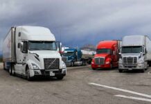 Trump Unleashes Tax-Free Diesel Semi trucks parked at a rest area under cloudy sky