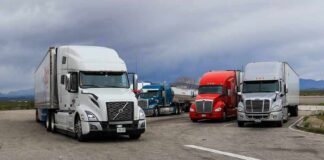 Trump Unleashes Tax-Free Diesel Semi trucks parked at a rest area under cloudy sky