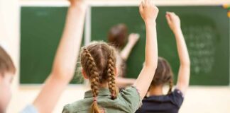 NYC Cover-Up? Over 16,000 Teachers Gone! students raising hands in a classroom