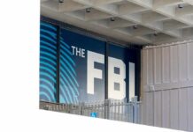 FBI Tracks Arson Suspect In Hours FBI sign on building facade behind metal fence