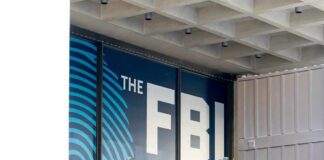FBI Tracks Arson Suspect In Hours FBI sign on building facade behind metal fence