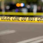 Police tape cordons off a street