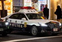 Japanese police car with lights on at night