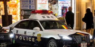 Japanese police car with lights on at night