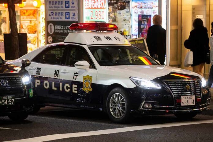 Japanese police car with lights on at night