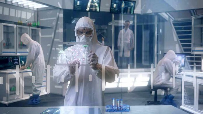 Scientist in hazmat suit using a transparent digital tablet in a lab