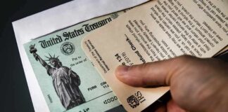 Trump Checks Hit 30 States Hand holding IRS letter with U.S. Treasury check