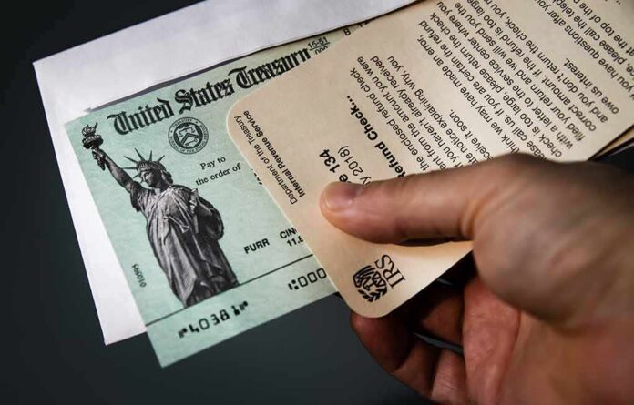 Hand holding IRS letter with U.S. Treasury check