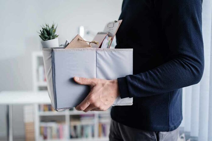 Person carrying a box of office items