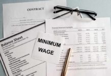 Seattle Minimum Wage Jumps In 2027 Minimum wage note on financial documents with glasses and pen