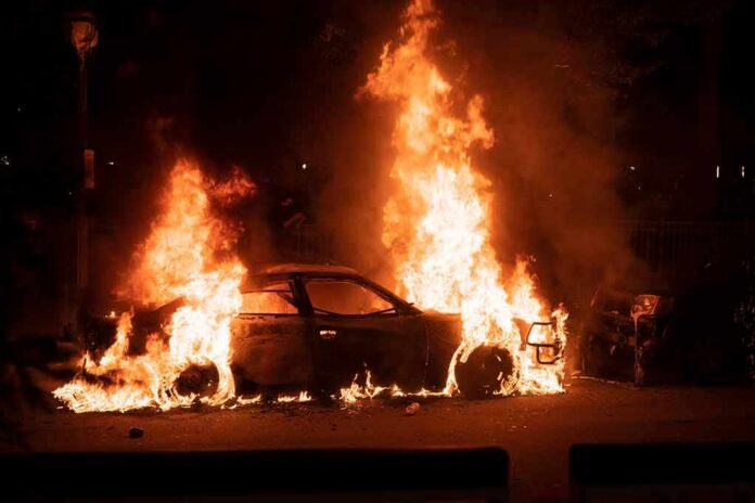 shutterstock_1744512746 Burning car engulfed in flames at night
