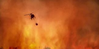Campfire Negligence Turns Deadly Helicopter fights massive wildfire over burning forest