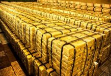 Central Banks Buy Gold As Prices Fall Stacks of gold bars strapped together in a vault