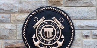 Bronze emblem of the United States Coast Guard mounted on a stone wall