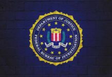 Shock Numbers From FBI’s 95-Day Push FBI seal painted on a dark brick wall