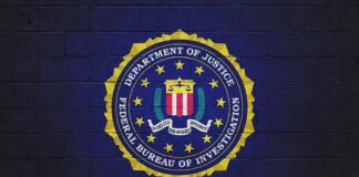 Shock Numbers From FBI’s 95-Day Push FBI seal painted on a dark brick wall