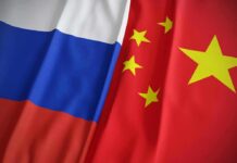 Trump Dismisses Claims About Iran’s Foreign Backers Russian and Chinese flags side by side