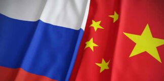 Trump Dismisses Claims About Iran’s Foreign Backers Russian and Chinese flags side by side