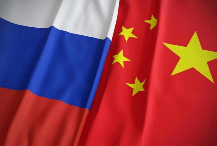 shutterstock_2118595412 Russian and Chinese flags side by side