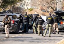 Medical Risk Twist In Twin Disappearance Police and sheriff officers gather around vehicles on a suburban street