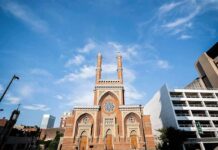 Millions Flow Into NYC Hate Prevention historic brick church with twin towers against blue sky