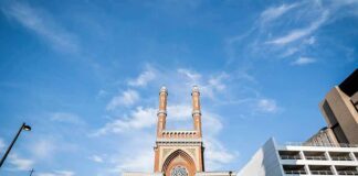 Millions Flow Into NYC Hate Prevention historic brick church with twin towers against blue sky