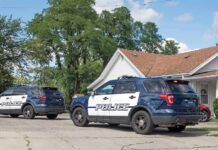 Game Night Becomes Abduction Case Two police SUVs parked near a suburban house