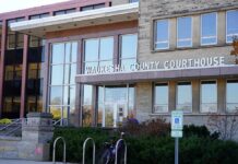 21-Year-Old Faces a Felony Hate Crime For Shoving a Man?! Waukesha County Courthouse entrance with glass facade and signage