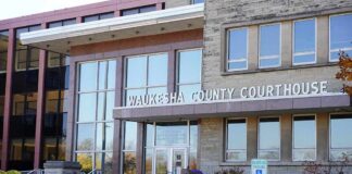 21-Year-Old Faces a Felony Hate Crime For Shoving a Man?! Waukesha County Courthouse entrance with glass facade and signage