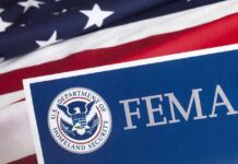 Isaias Looms: FEMA Money Unlocked Fast FEMA sign with U.S. flag background