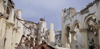 Tsunami Sirens Blaze Across Pacific Coast Interior view of a destroyed building with collapsed arches and debris