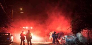 Argument Explodes Into Fire Attack Firefighters and police at a nighttime car fire scene