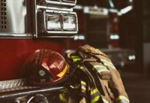Firefighter helmet and turnout gear resting on a fire engine