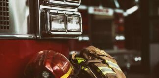 Firefighter helmet and turnout gear resting on a fire engine