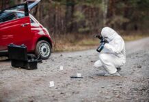 Baby Abandoned After Gunfire Forensic investigator photographing evidence near a red car on a rural road